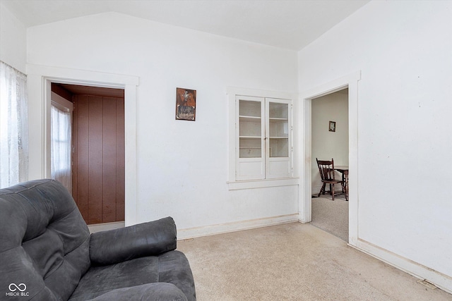 living room with vaulted ceiling and carpet flooring