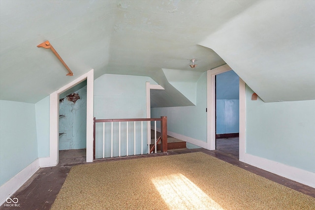 additional living space featuring lofted ceiling