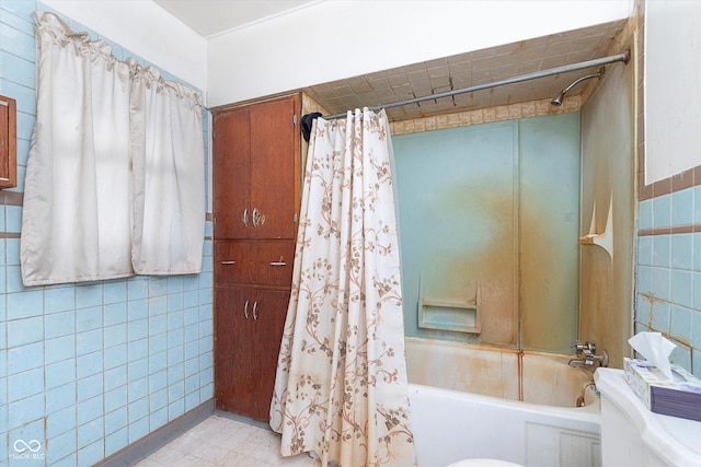 bathroom with shower / bath combination with curtain and tile walls