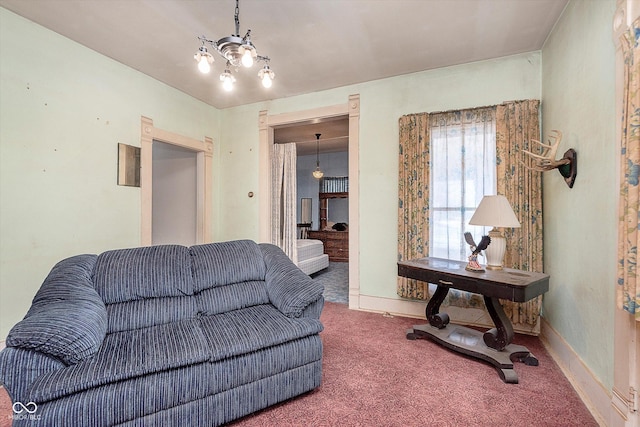 living room featuring carpet floors and an inviting chandelier