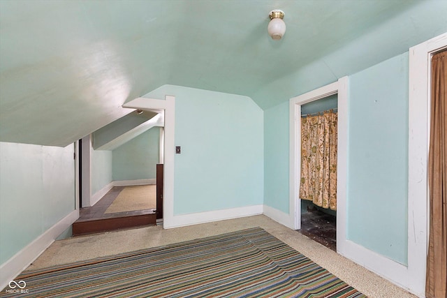 additional living space featuring vaulted ceiling