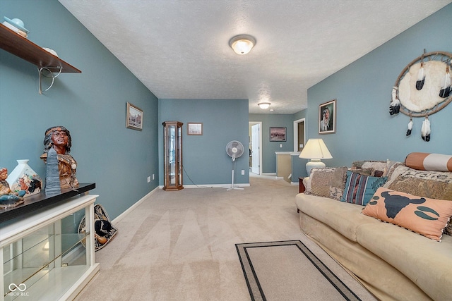 living room featuring light colored carpet and a textured ceiling