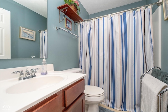 bathroom featuring vanity, toilet, and a shower with shower curtain