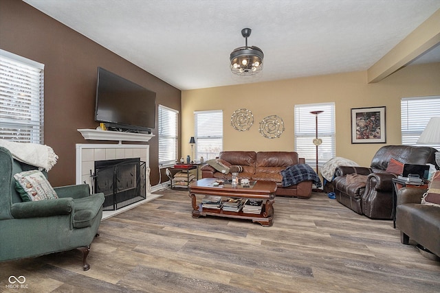 living room with hardwood / wood-style floors and a tile fireplace