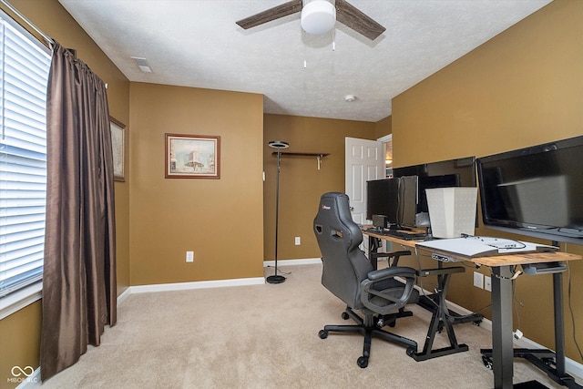 office area featuring light carpet, a textured ceiling, and ceiling fan