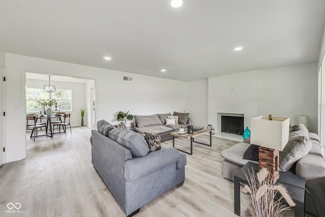 living room featuring light hardwood / wood-style flooring and a fireplace