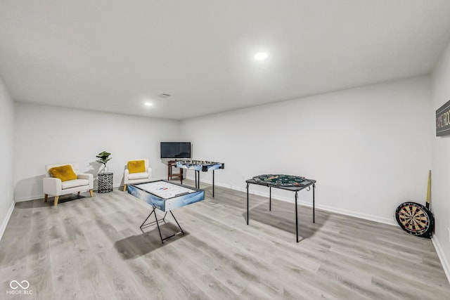 sitting room featuring light hardwood / wood-style flooring