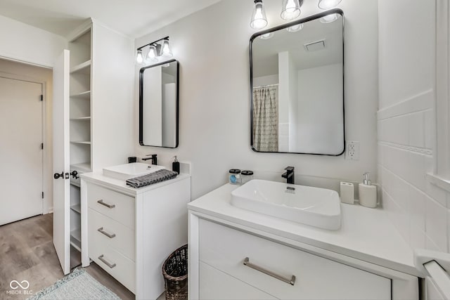 bathroom with hardwood / wood-style flooring and vanity