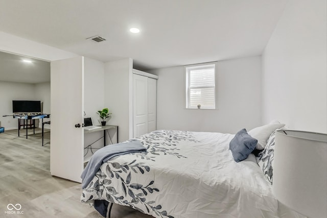 bedroom featuring light hardwood / wood-style flooring and a closet