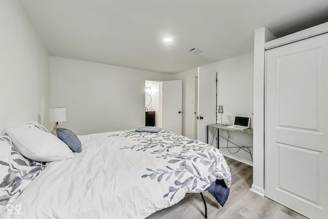 bedroom featuring hardwood / wood-style flooring and a closet