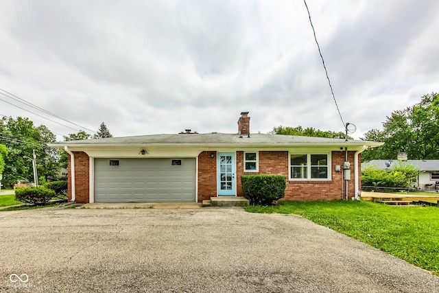 ranch-style home with a garage and a front yard