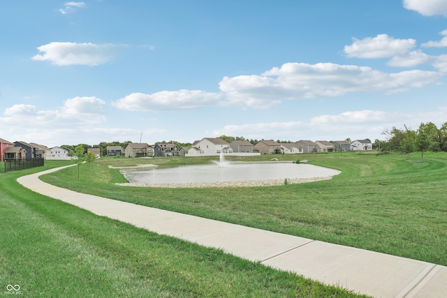 view of home's community with a lawn and a water view