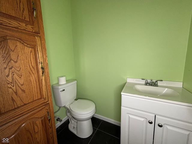 bathroom featuring tile patterned floors, vanity, and toilet