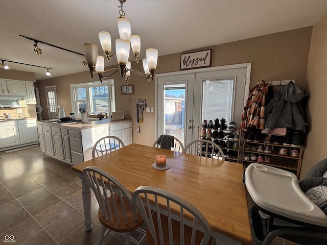 dining room with a chandelier and french doors