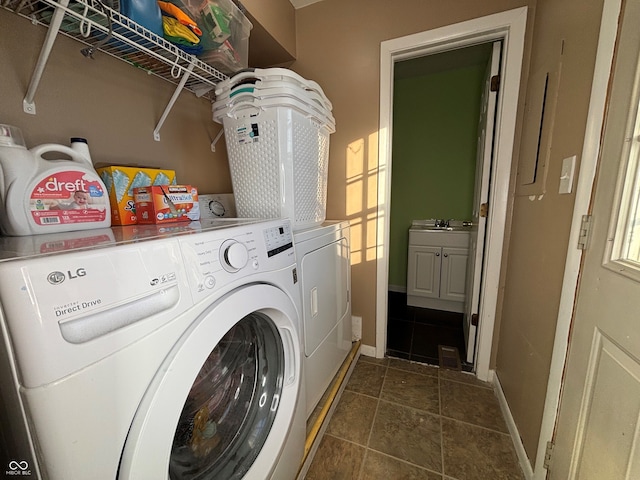 laundry area featuring separate washer and dryer and dark tile patterned floors