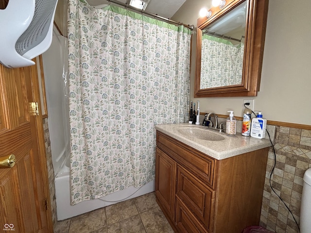 bathroom with vanity, tile patterned flooring, shower / tub combo, and tile walls