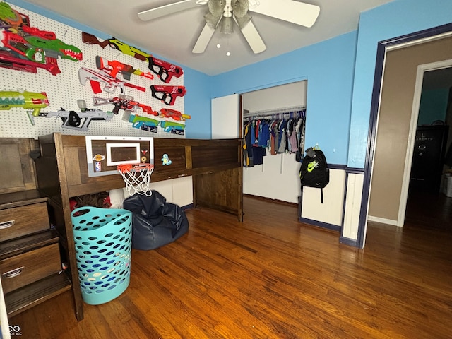 bedroom with ceiling fan, dark hardwood / wood-style flooring, and a closet