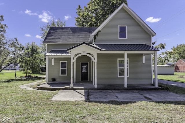 view of front of property with covered porch and a front lawn