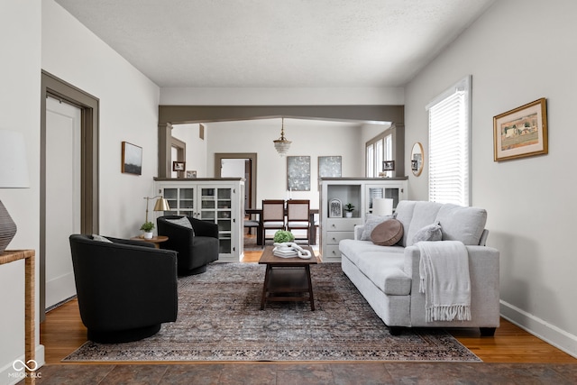 living room with hardwood / wood-style floors and a textured ceiling