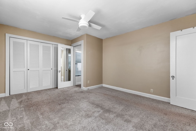 unfurnished bedroom featuring carpet floors, ceiling fan, and a closet