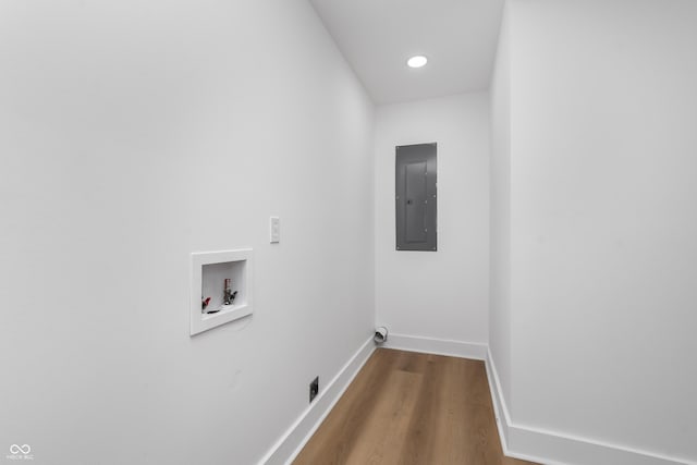 laundry area featuring hookup for a washing machine, hardwood / wood-style floors, and electric panel