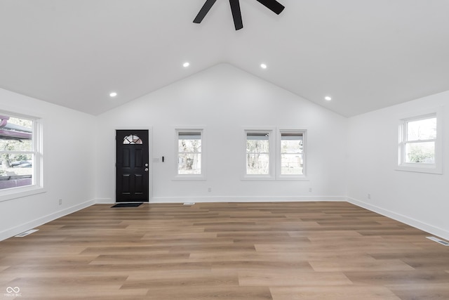 foyer featuring ceiling fan, high vaulted ceiling, and light wood-type flooring