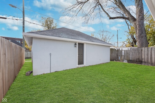 back of property featuring an outbuilding and a lawn