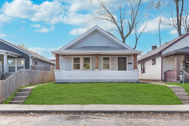 bungalow-style house featuring a front lawn