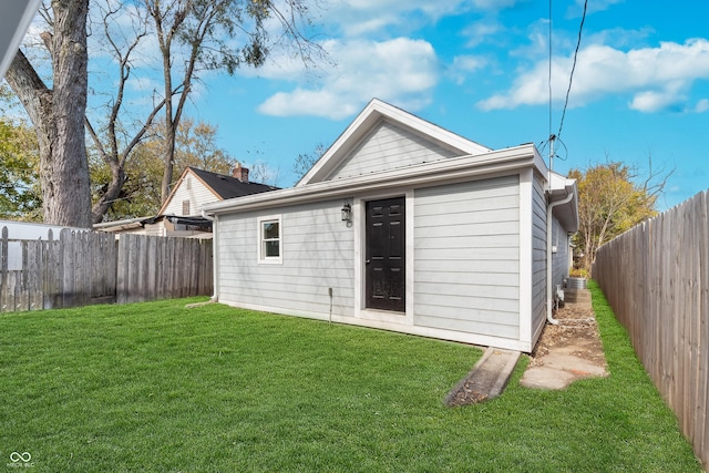 rear view of property featuring a yard