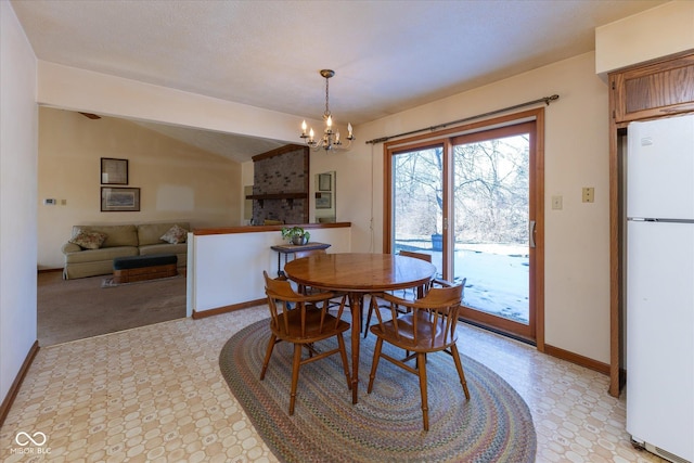 dining area with an inviting chandelier and lofted ceiling