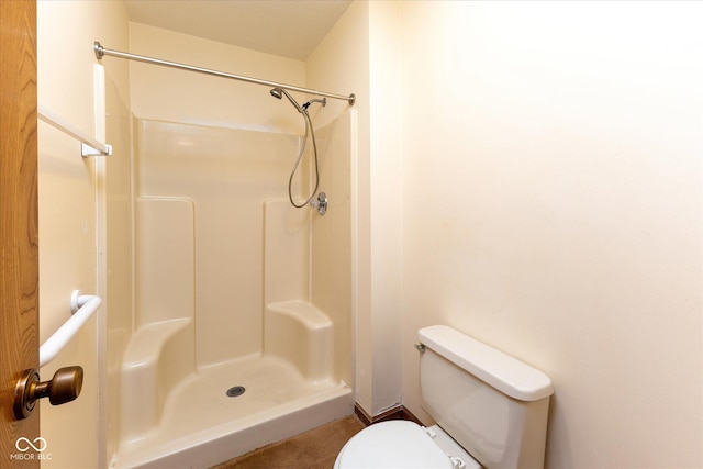 bathroom with toilet and walk in shower