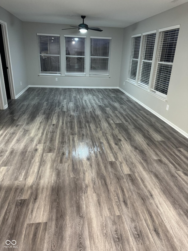 interior space with dark hardwood / wood-style floors and ceiling fan