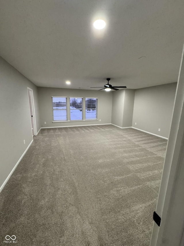 carpeted empty room featuring a textured ceiling and ceiling fan