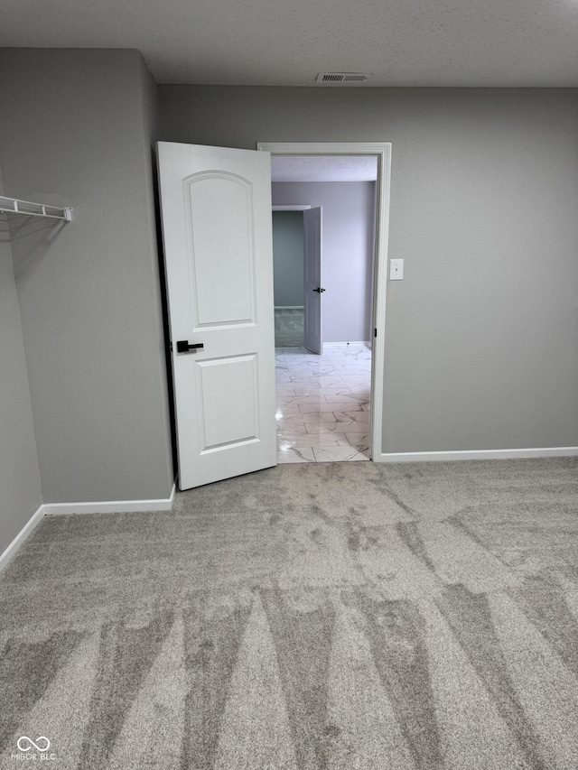 empty room featuring light carpet