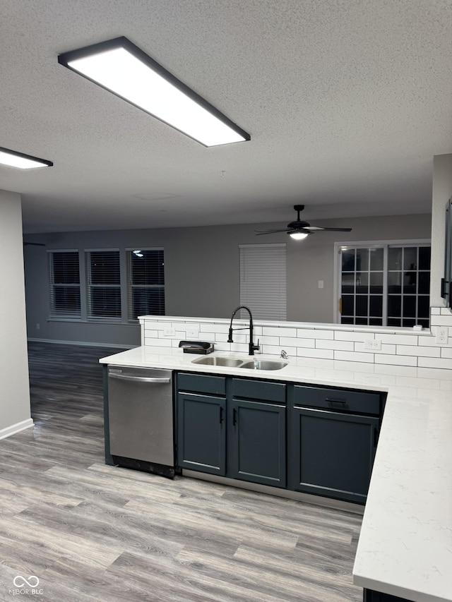 kitchen featuring sink, hardwood / wood-style flooring, gray cabinets, and dishwasher