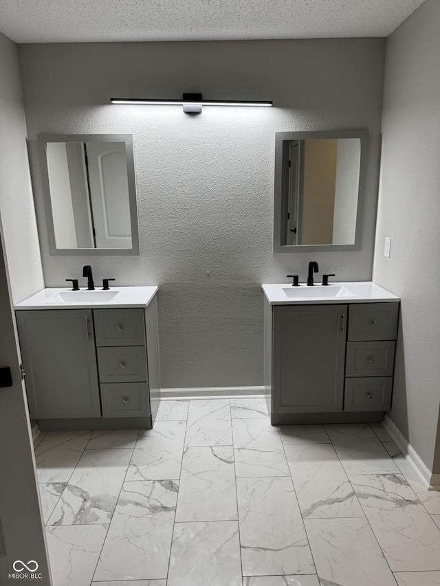 bathroom with vanity and a textured ceiling