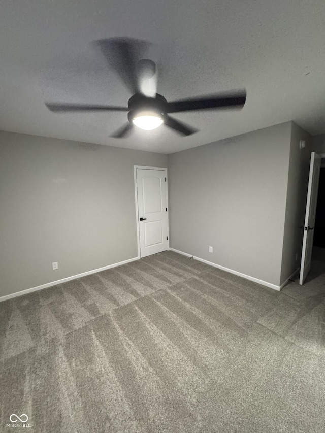 unfurnished room featuring ceiling fan, a textured ceiling, and carpet flooring