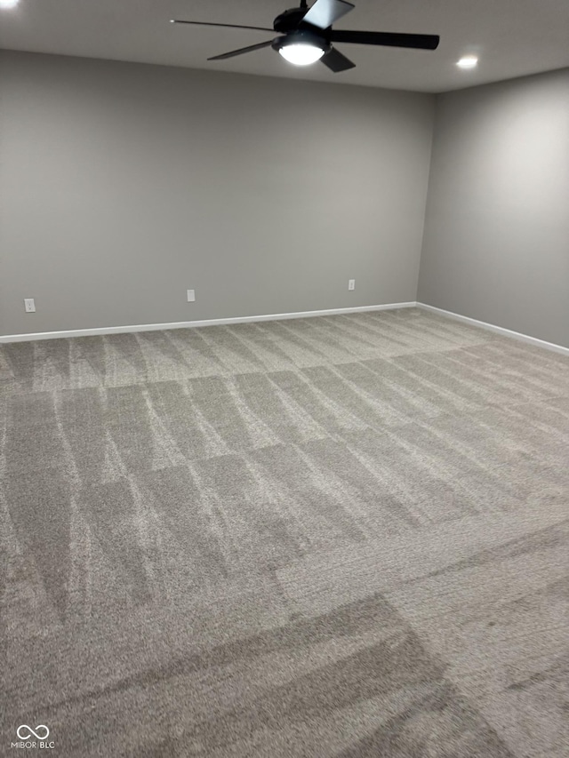 empty room with ceiling fan and light colored carpet