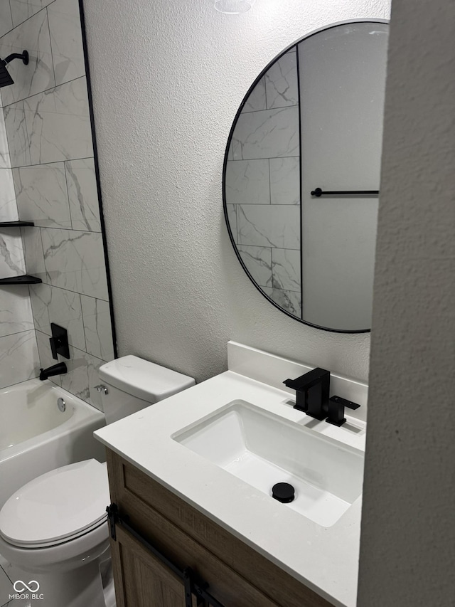 full bathroom featuring vanity, tiled shower / bath combo, and toilet