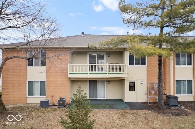 rear view of house featuring a balcony and central air condition unit