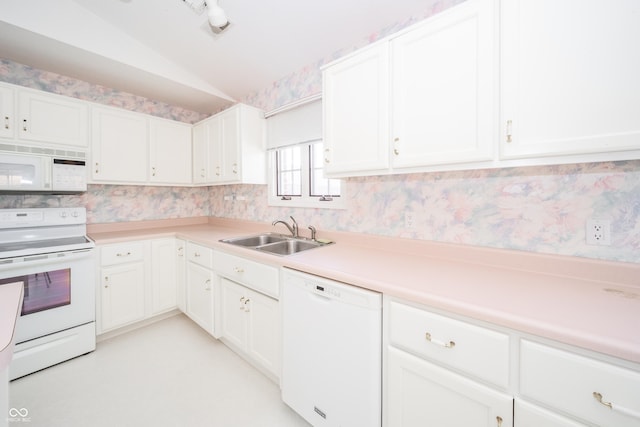 kitchen with lofted ceiling, sink, white cabinets, and white appliances