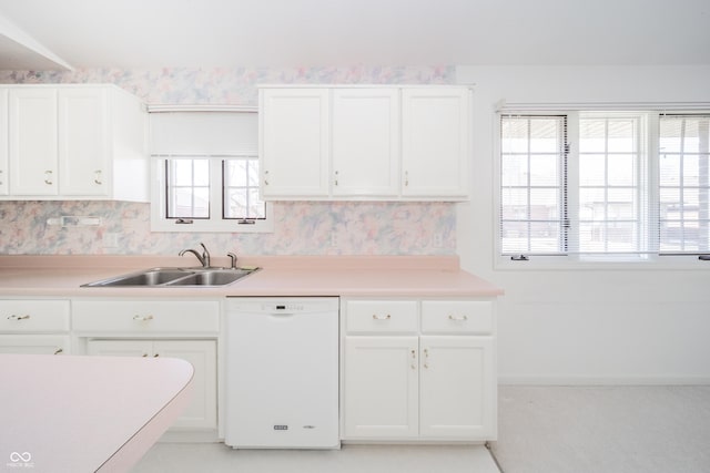 kitchen featuring white cabinetry, dishwasher, and sink