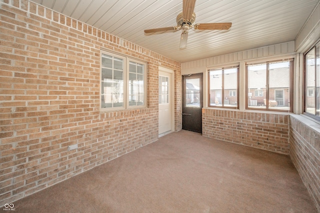 unfurnished sunroom with ceiling fan