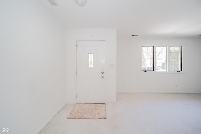 view of carpeted foyer