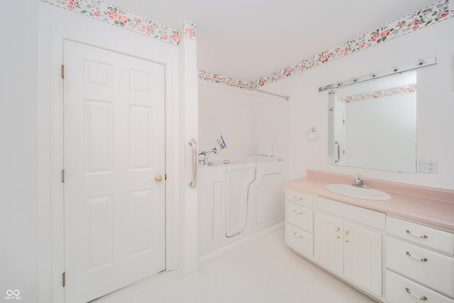 bathroom featuring vanity and a bath