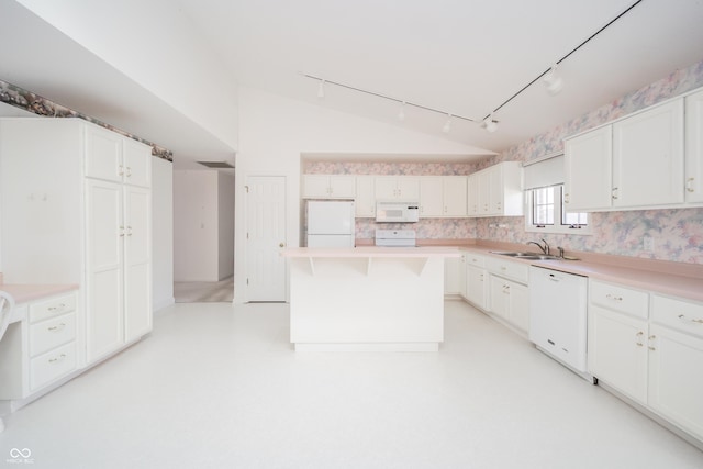 kitchen featuring white cabinetry, a center island, sink, and white appliances