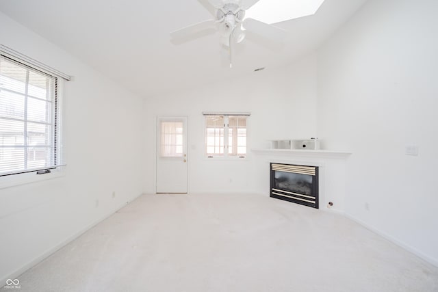 unfurnished living room with ceiling fan, lofted ceiling, and carpet floors