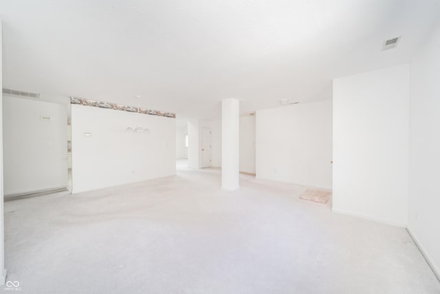 spare room featuring light colored carpet