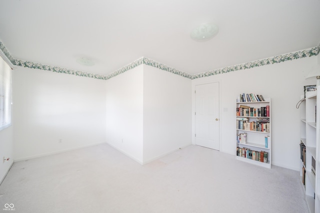 unfurnished room with light carpet