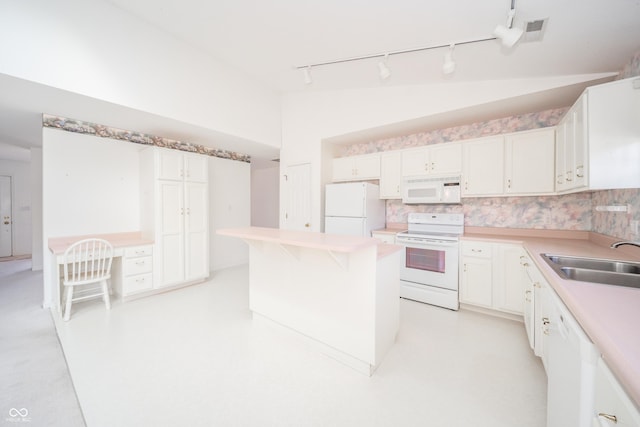 kitchen featuring white cabinetry, sink, and white appliances